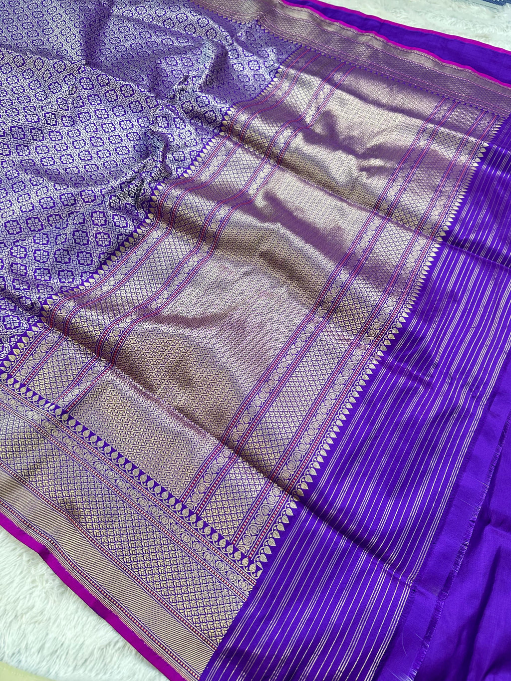 A Beautiful and Delicate Purple saree that appears to be a contemporary take on classic Kadua Banarasi weaving.
